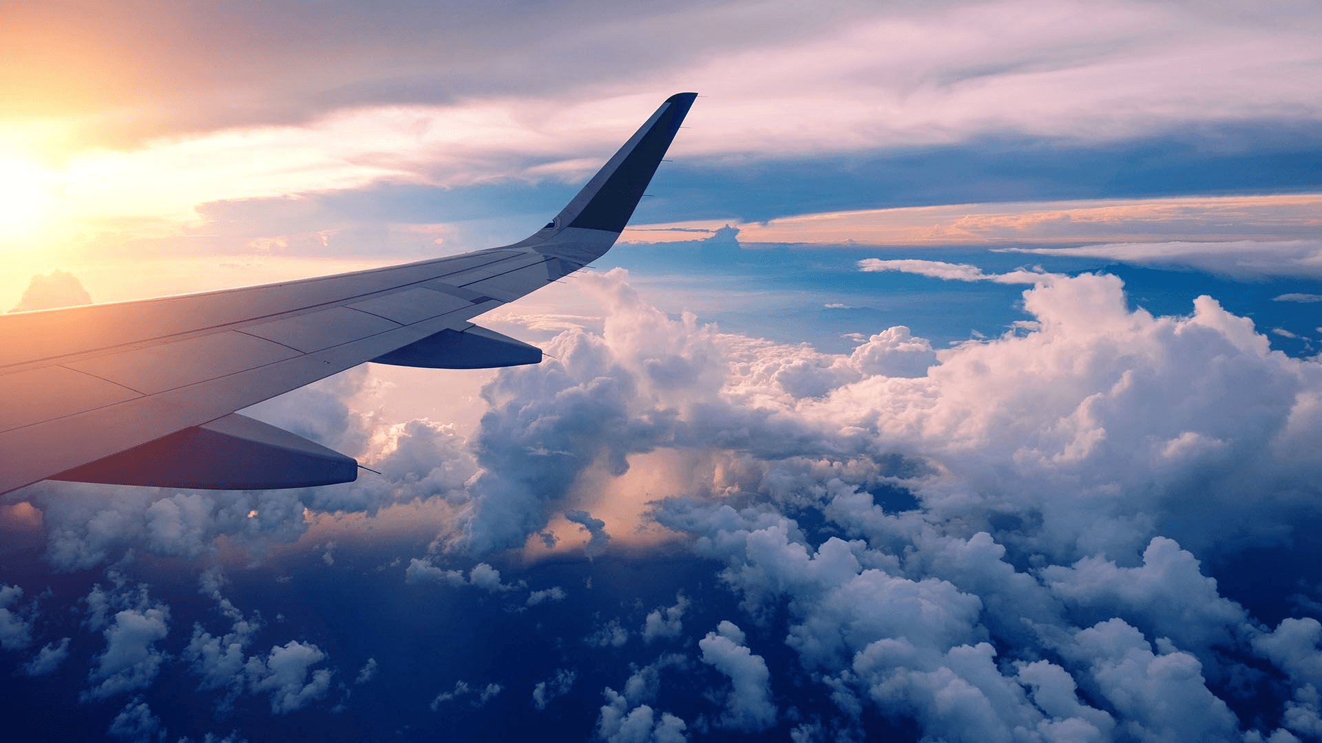 Airplane wing above clouds